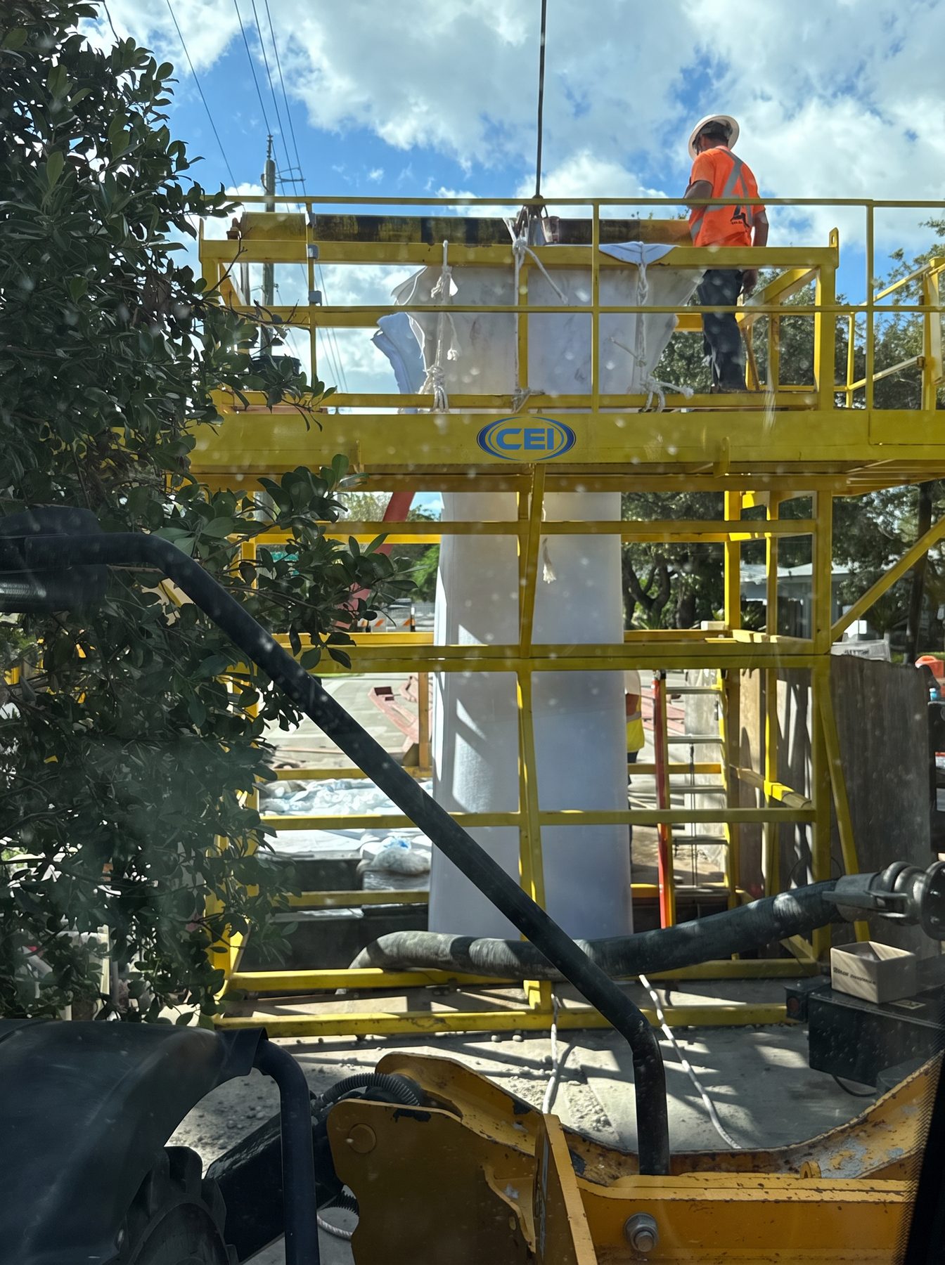 CEI CIPP crew inverting a resin-saturated liner from the top of the inversion tower on an active Florida jobsite